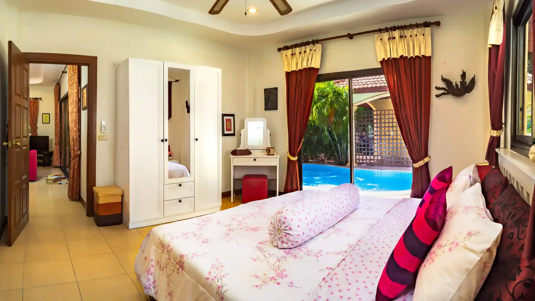 Bon Island Villa master bedroom with double bed, mirrored wardrobe and pool view