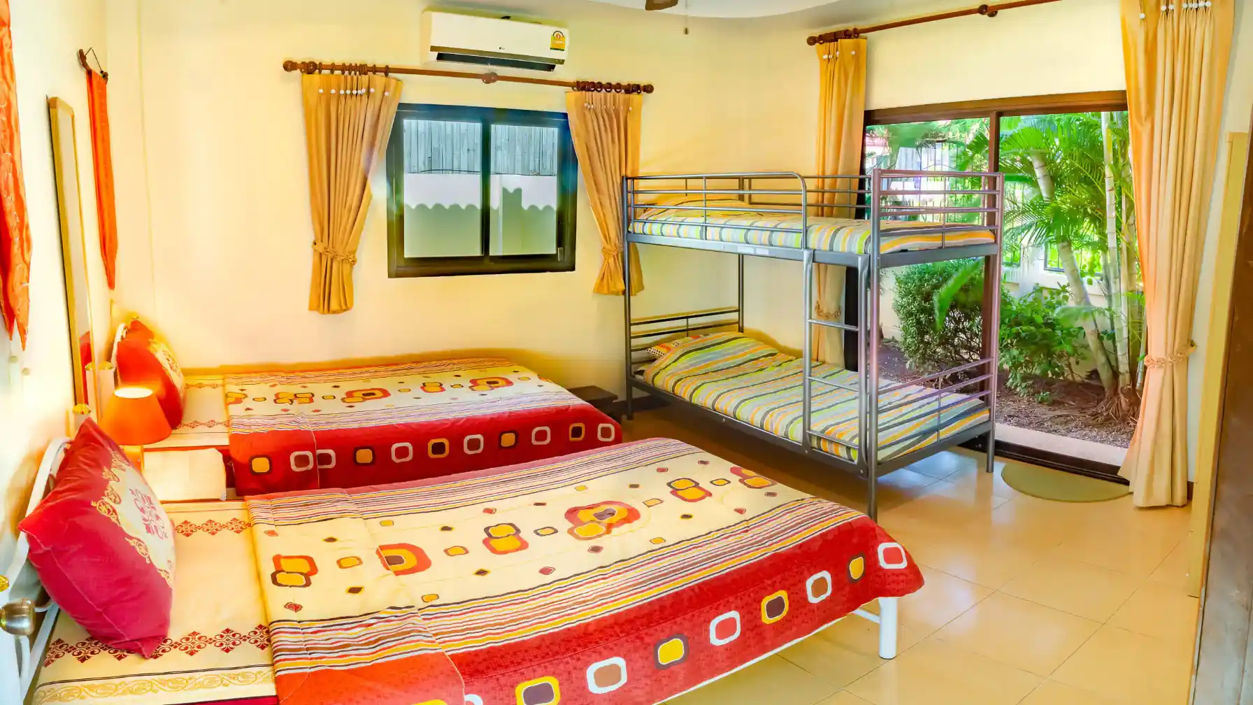 Bon Island Villa second bedroom with colourful bedding and air conditioning
