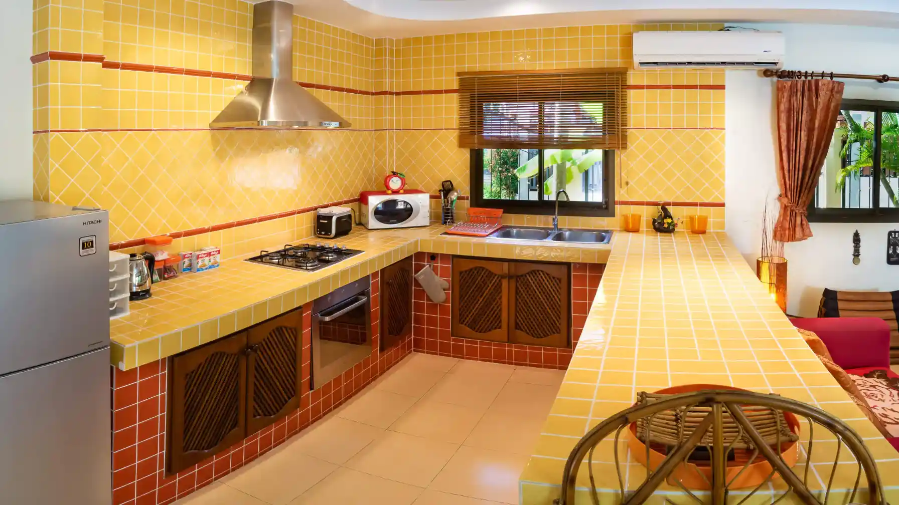 Bon Island Villa kitchen counter with microwave, hob and kitchen bar seating