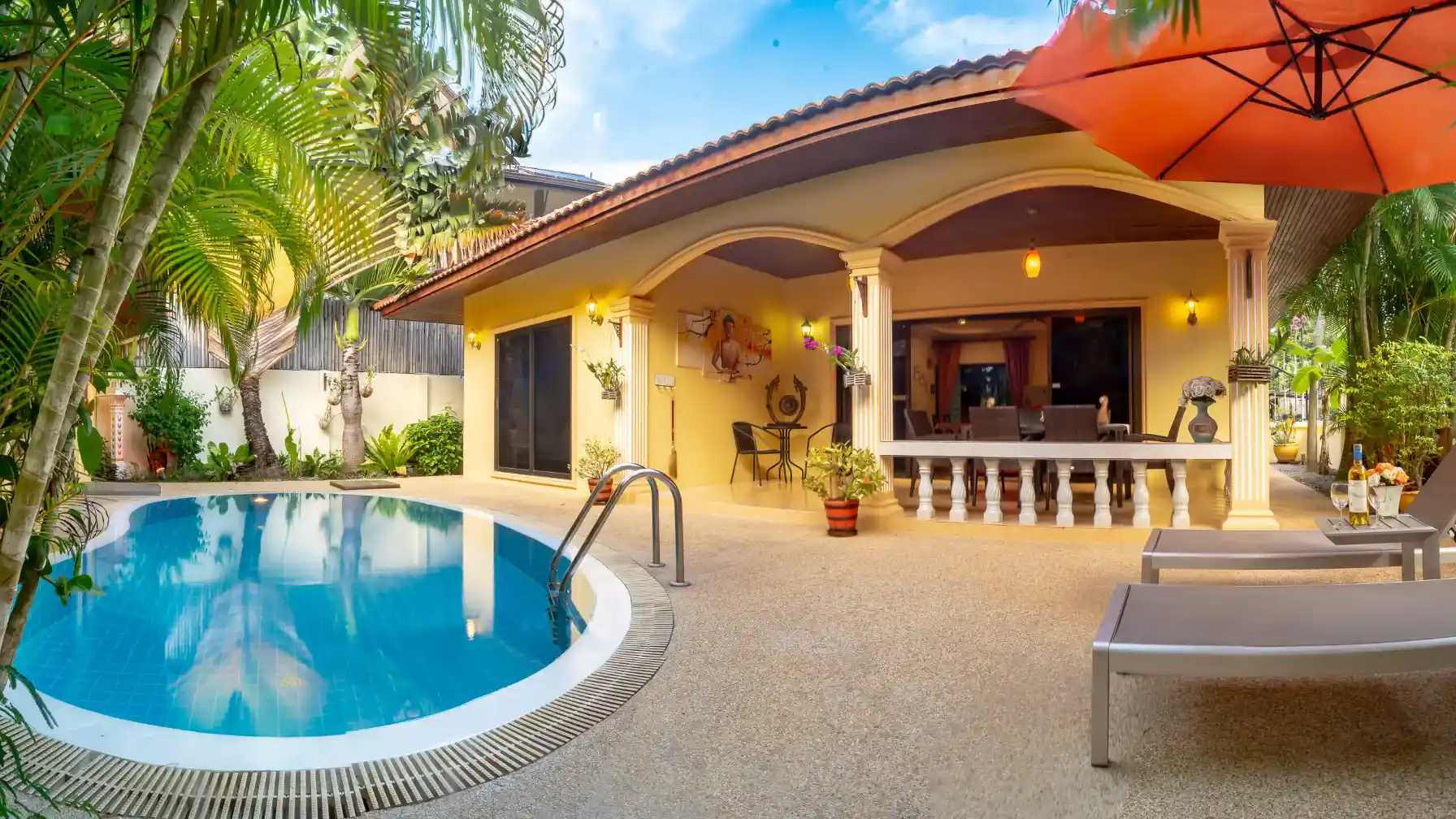 Bon Island Villa private pool with sun lounger and villa exterior at dusk, Rawai Phuket