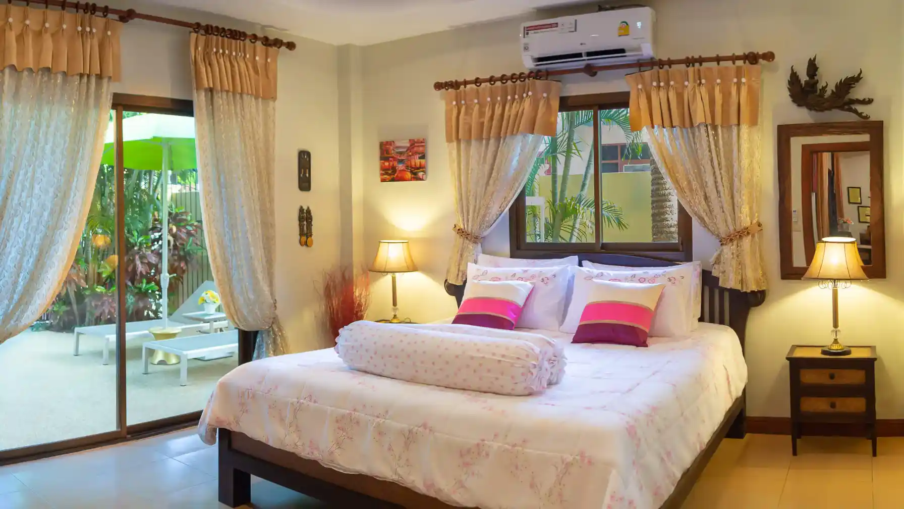 Coral Island Villa master bedroom with double bed, Thai decor and patio doors to garden