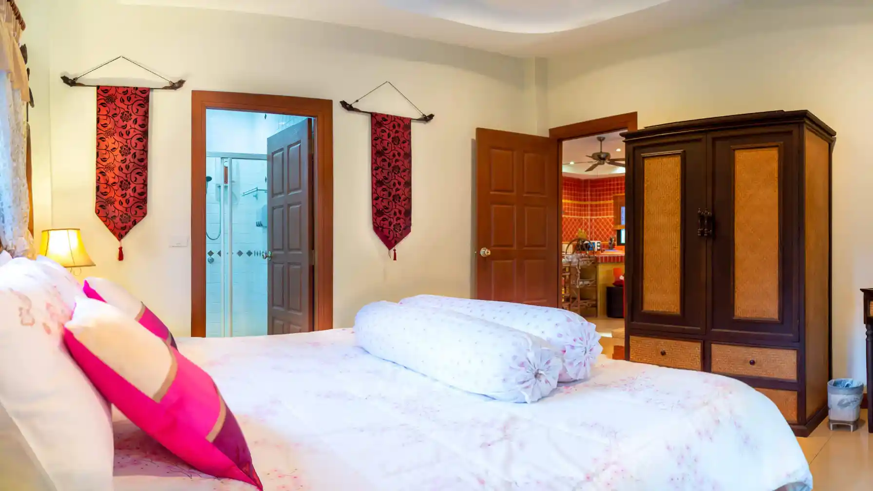 Coral Island Villa master bedroom interior with wardrobe and bedside lamps