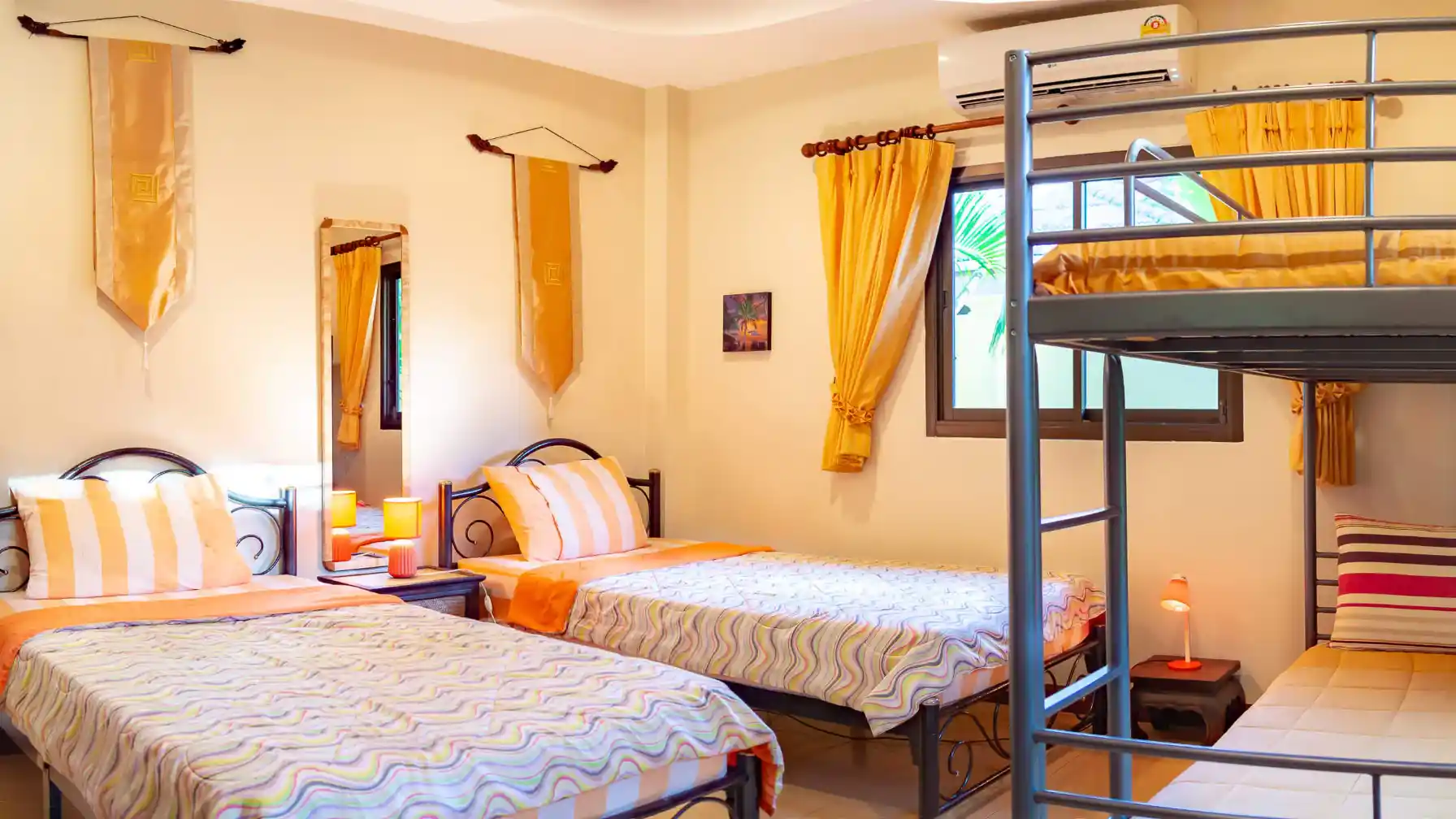 Coral Island Villa second bedroom with colourful decor and patio doors to garden
