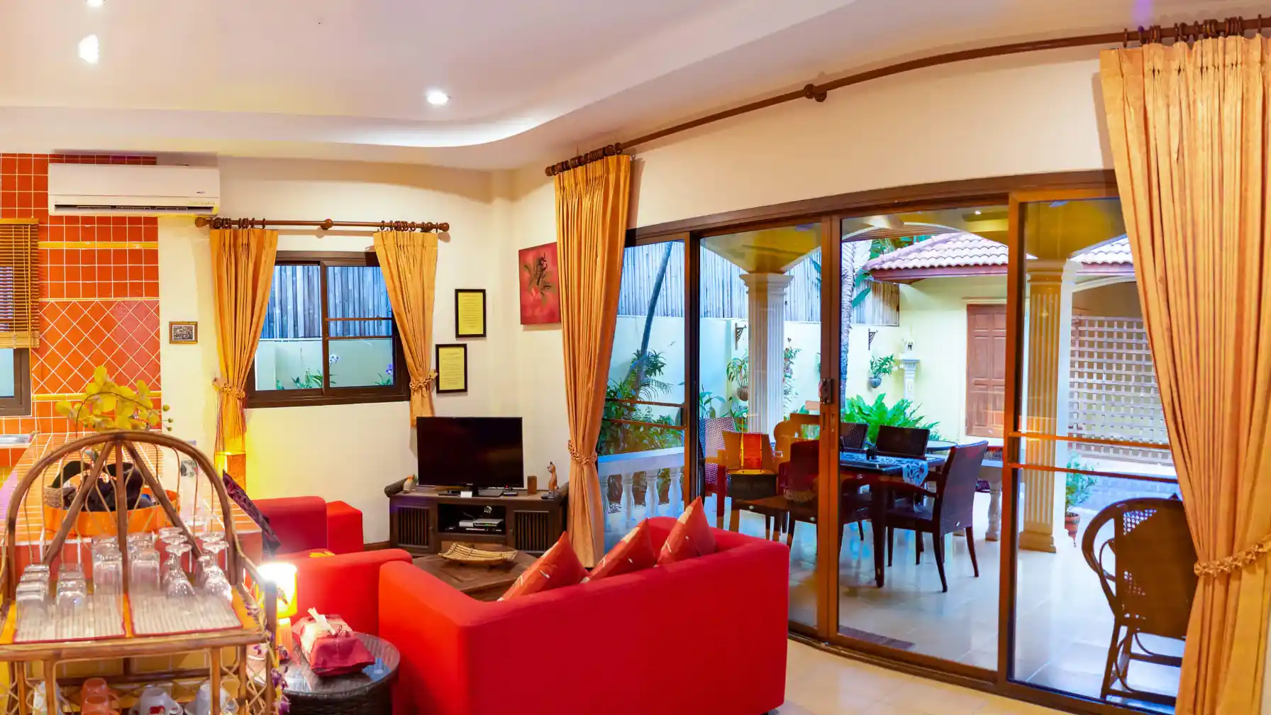 Coral Island Villa dining area with sliding doors opening to the pool courtyard