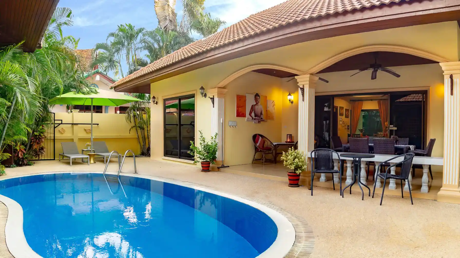 Coral Island Villa pool and villa exterior with arched covered patio